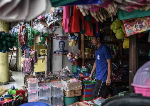 Campaign posters remain on the walls in suburban Manila even as Rodrigo Duterte is named the countrys president-elect. Picture: AFP/Getty Images