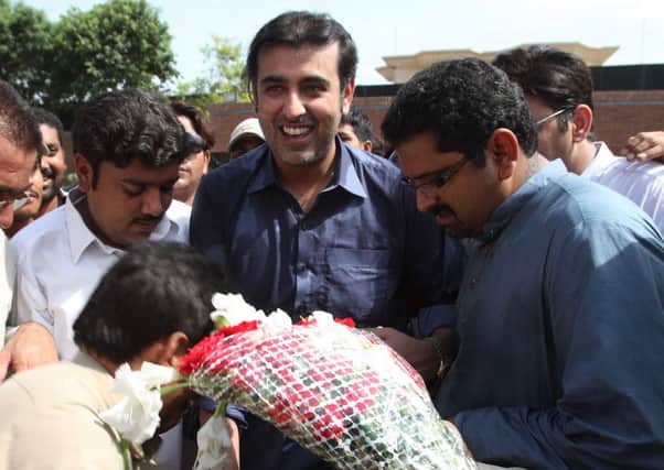Abdul Qadir Gilani, centre, accepts flowers from supporters in Multan. Picture: AFP/Getty Images