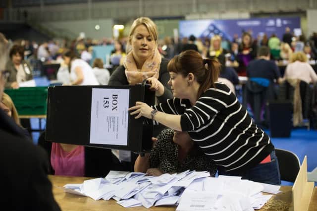 Volunteers empty ballot boxes at the Glasgow count. Turnout at the Scottish Parliament elections was 55 per cent. Picture: John Devlin