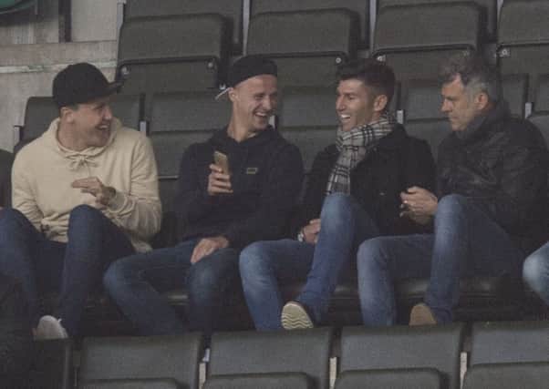 Celtic's Leigh Griffiths (centre left) was in attendance at Easter Road last night. Picture: SNS