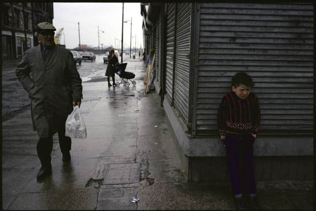 An upset child stands outside a shop in Govan. Picture: Raymond Depardon/Magnum