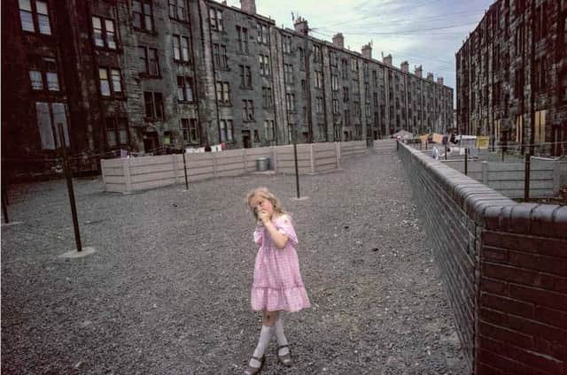 A girl in the back court of a Glasgow tenement. Picture: Raymond Depardon/Magnum