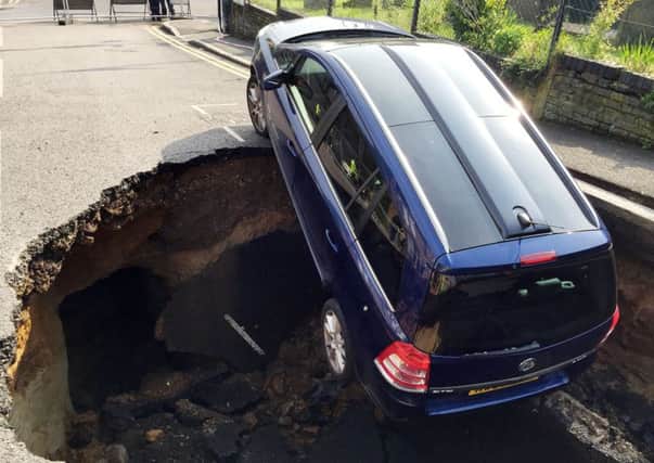 The Vauxhall Zafira partially disappeared down a sinkhole in Woodland Terrace in Greenwich, south-east London, in the early hours of Thursday morning. Picture: Joe Nerssessian/PA Wire