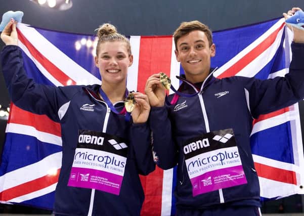 Great Britain's Tom Daley and Grace Reid celebrate with their gold medals after winning the 3m Synchro Diving Mixed final at the European Aquatics Championships in London. Picture: John Walton/PA Wire
