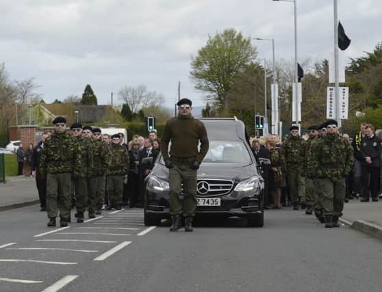 A guard of honour flanks the coffin of Michael Barr at his funeral in Strabane Co Tyrone