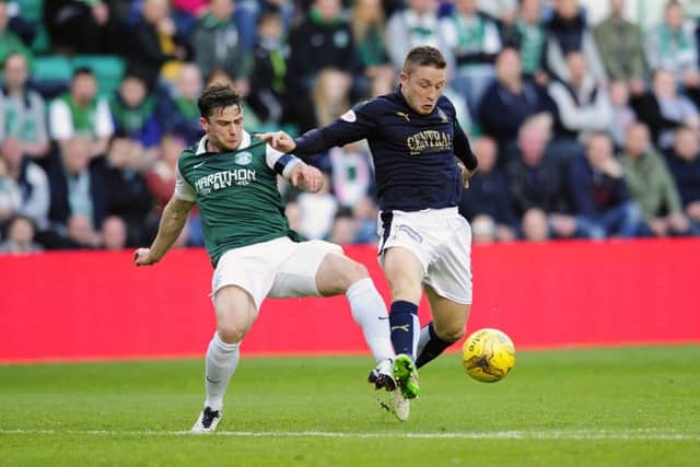 Hibernian's Lewis Stevenson tussles with John Baird of Falkirk. Picture: Michael Gillen