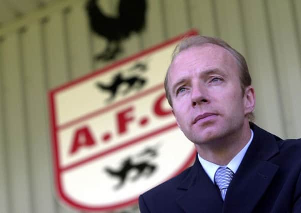 The Airdrieonians badge and former manager Steve Archibald. Picture Allan Milligan