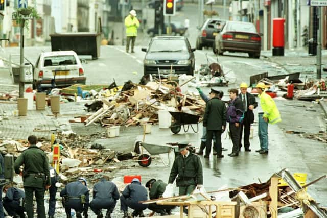 Forensic teams sift through the debris in the centre of Omagh  following a bomb blast