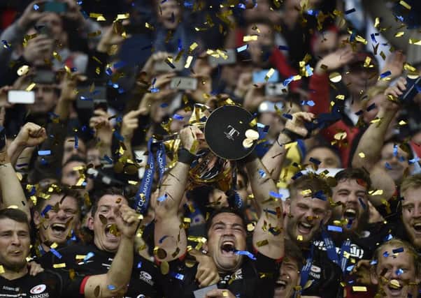 Saracens players celebrate with the trophy after winning the European Champions Cup final at the Parc Olympique Lyonnais. Picture: AFP/Getty Images