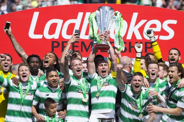 Celtic captain Scott Brown lifts the Ladbrokes Premiership trophy. Picture: SNS