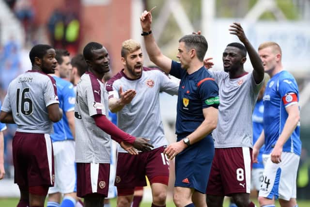 Hearts' Abiola Dauda (second from left) is shown a red card by referee Greg Aitken. Picture: PA