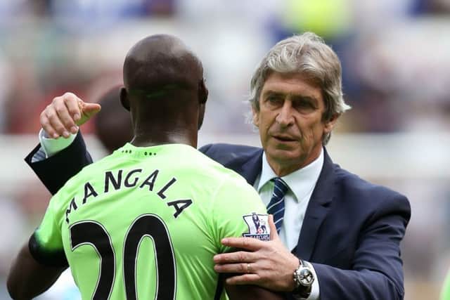 Outgoing manager Manuel Pellegrini embraces Eliaquim Mangala. Picture: PA