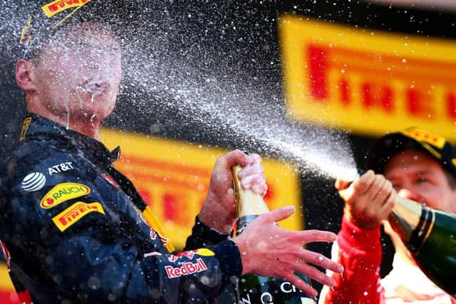 Max Verstappen gets some added sparkle as his astonishing feat of winning in his first outing for the Red Bull team is celebrated. Picture: Getty Images