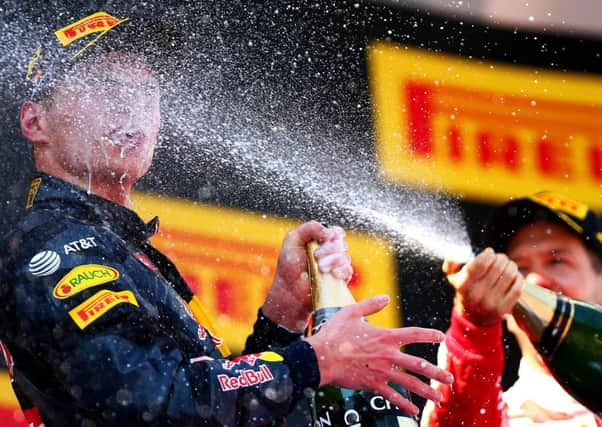 Max Verstappen gets some added sparkle  as his astonishing feat of winning in his first outing for the Red Bull team is celebrated. Picture: Getty Images