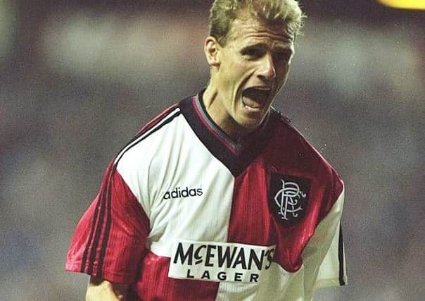 Gordon Durie celebrates a goal while wearing the original red and white quartered away kit. Picture: Getty Images