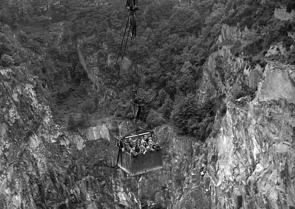 Workers transported over Rubislaw Quarry which was more than 130 metres deep by the time it closed in 1971. PIC TSPL