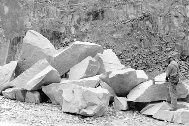 A quarryman wields a large sledge-hammer at Sclattie Quarrie, Bucksburn. PIC British Geological Survey/NERC