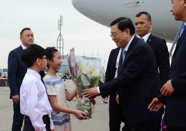 Zhang Dejiang (centre right) receiving flowers from children upon his arrival at Hong Kong's international airport. 
Picture: AFP/Getty Images