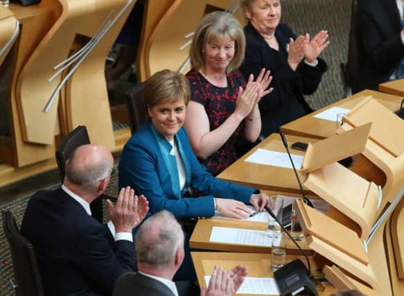 Fellow MSP's congratulate Nicola Sturgeon after she was voted in as the First Minister . Picture: PA