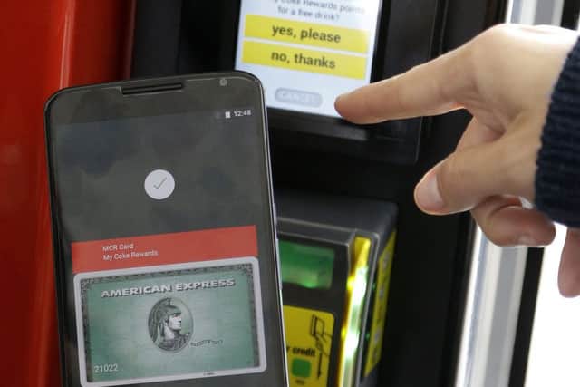 A Google employee gives a demonstration of Android Pay on a phone. Picture: AP/Jeff Chiu