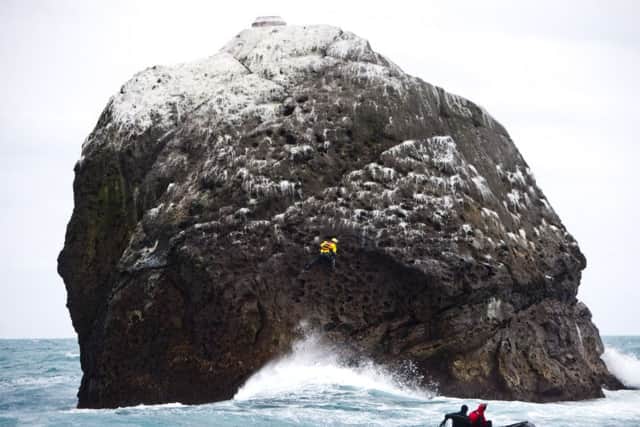 Nick Hancock (yellow dry suit), on the on the way down the face of Rockall, on his reconnaissance mission for a future 60 day occupation of Rockall. Picture: Contributed.