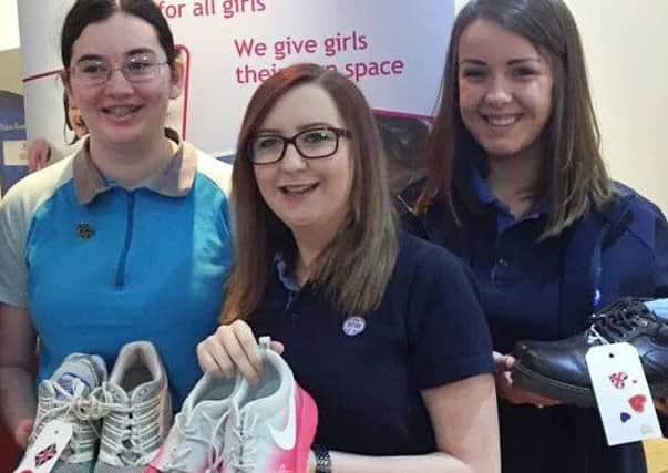 Rachael Rowbottom, centre, with a pair of the shoes donated for a project run by charity Edinburgh Cares to collect shoes for Syrian refugees. Picture: Contributed