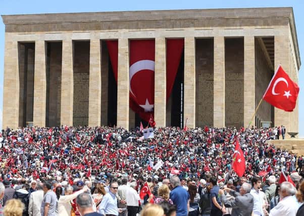 People hold Turkish flags in front of the mausoleum of Mustafa Kemal Ataturk during the "Commemoration of Ataturk, Youth and Sports Day". Picture: AFP/Getty Images