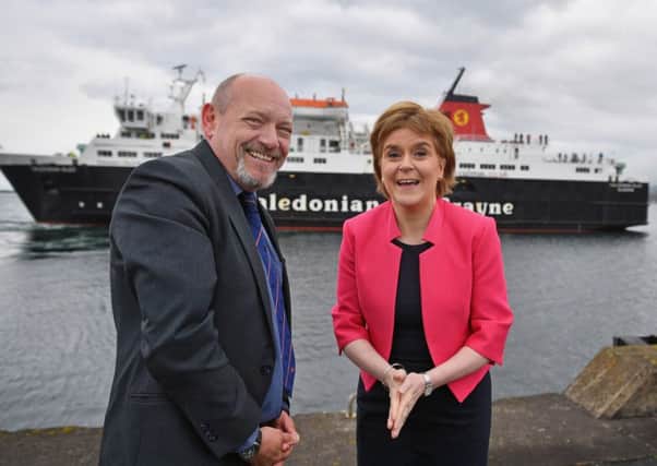 First Minister Nicola Sturgeon and Calmac MD Martin Dorchester. Picture: Getty Images