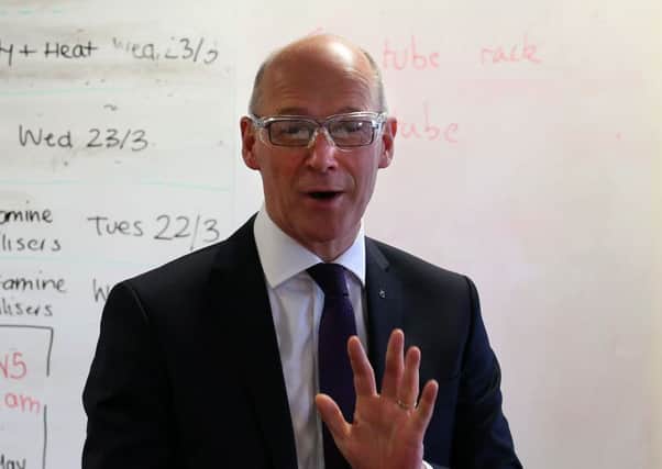 Swinney visits his former school, Forrester High School in Edinburgh, for a science class where pupils were studying the DNA of kiwi fruit. Picture: Andrew Milligan/PA