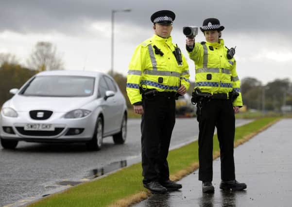 Police use a speed gun to collect evidence of drivers breaking the limit. Picture: John Devlin