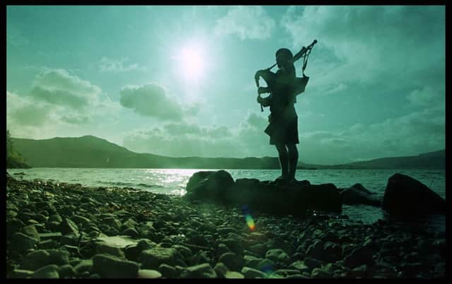 A piper plays a lament on Skye. The head of the Lockhart clan passed away in November. Picture: Contributed/Donald Macleod