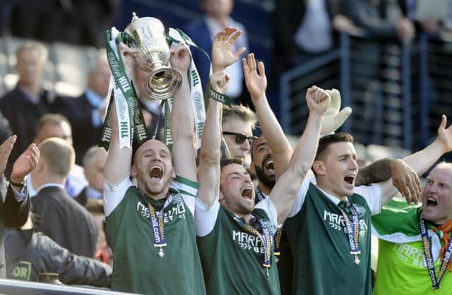 Hibs captain David Gray lifts the Scottish Cup. Picture: Neil Hanna