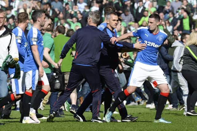 Rangers captain Lee Wallace is ushered off the park at full-time. Picture: Rob Casey/SNS