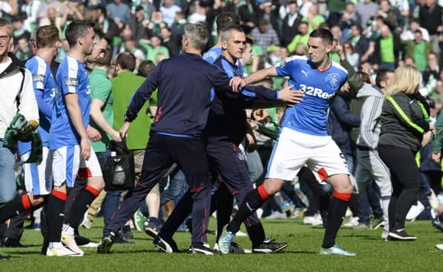 Rangers captain Lee Wallace is ushered off the park at full-time. Picture: Rob Casey/SNS