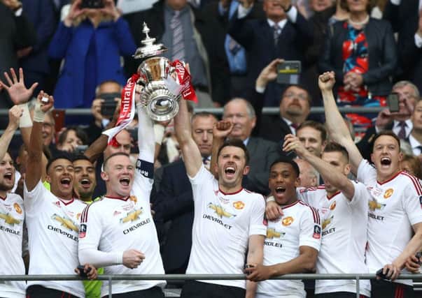 Manchester United captain Wayne Rooney got his hands on the FA Cup for the first time in his career.  Picture: Paul Gilham/Getty Images