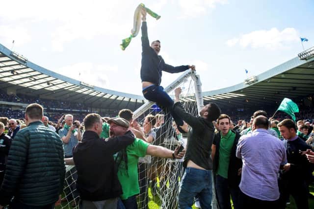 Hibernian fans rushed the pitch as they celebrated their side's historic win. Picture: SNS Group