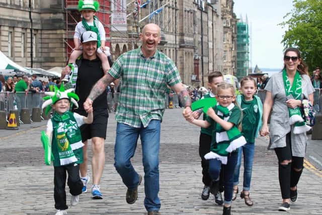 The Naples family skip up the Royal Mile in celebration. Picture: SWNS