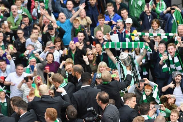 Hibernian players stand on the open top bus. Picture: Getty