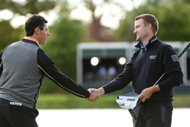 A victorious Rory McIlroy shakes hands with joint runner-up Russell Knox. Picture: Getty