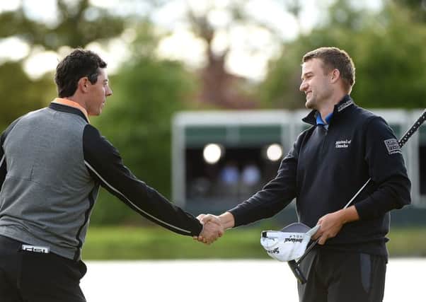 A victorious Rory McIlroy shakes hands with joint runner-up Russell Knox. Picture: Getty