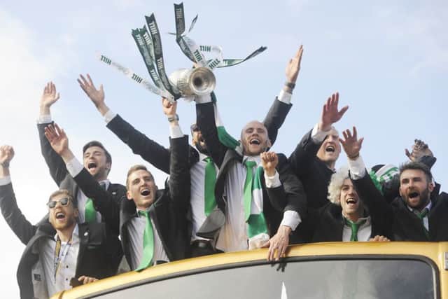 Hibernian heroes aboard the open-top bus with the cup. Picture: Greg Macvean