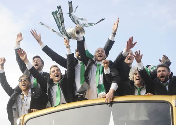 Hibernian heroes aboard the open-top bus with the cup. Picture: Greg Macvean