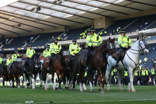 Mounted police patrol the Hampden pitch after the cup final. Picture: Getty