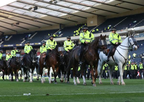 Mounted police patrol the Hampden pitch after the cup final. Picture: Getty