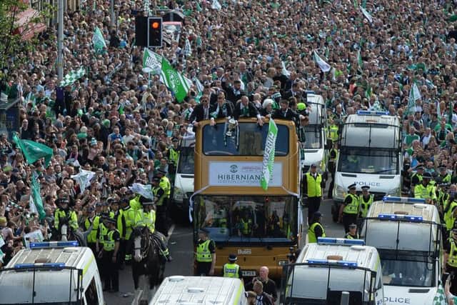 Fans line Leith Walk in their tens of thousands as the victorious Hibs team coach inches its way along. Picture: Getty Images