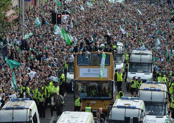 Fans line Leith Walk in their tens of thousands as the victorious Hibs team coach inches its way along. Picture: Getty Images