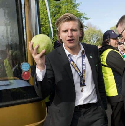 Cummings brandishes a cabbage during Hibernian's victory parade. Picture: SNS Group