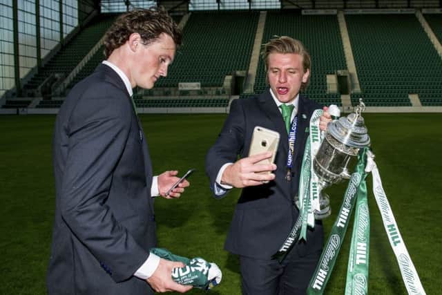 Jason Cummings (right) and Liam Henderson celebrate with the cup at Easter Road. Picture: SNS Group