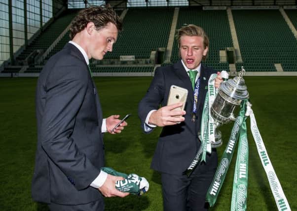 Jason Cummings (right) and Liam Henderson celebrate with the cup at Easter Road. Picture: SNS Group