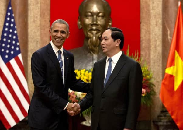 President Barack Obama and Vietnamese President Tran Dai Quang shake hands at the Presidential Palace in Hanoi. Picture: AP